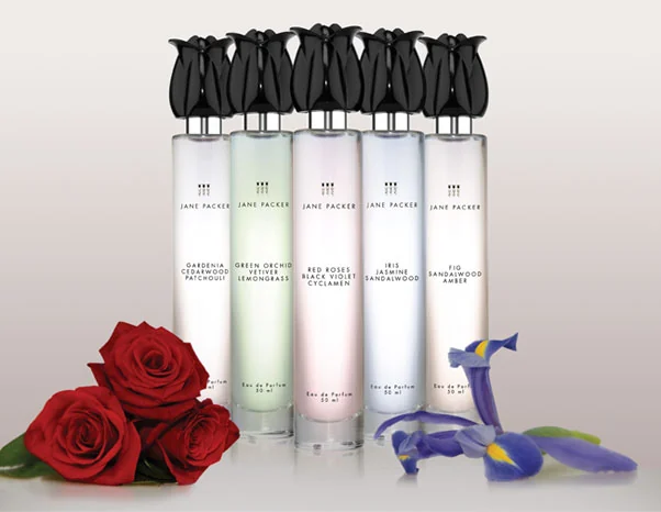 The Jane Packer fragrance range shown as a row of bottles with fresh flowers