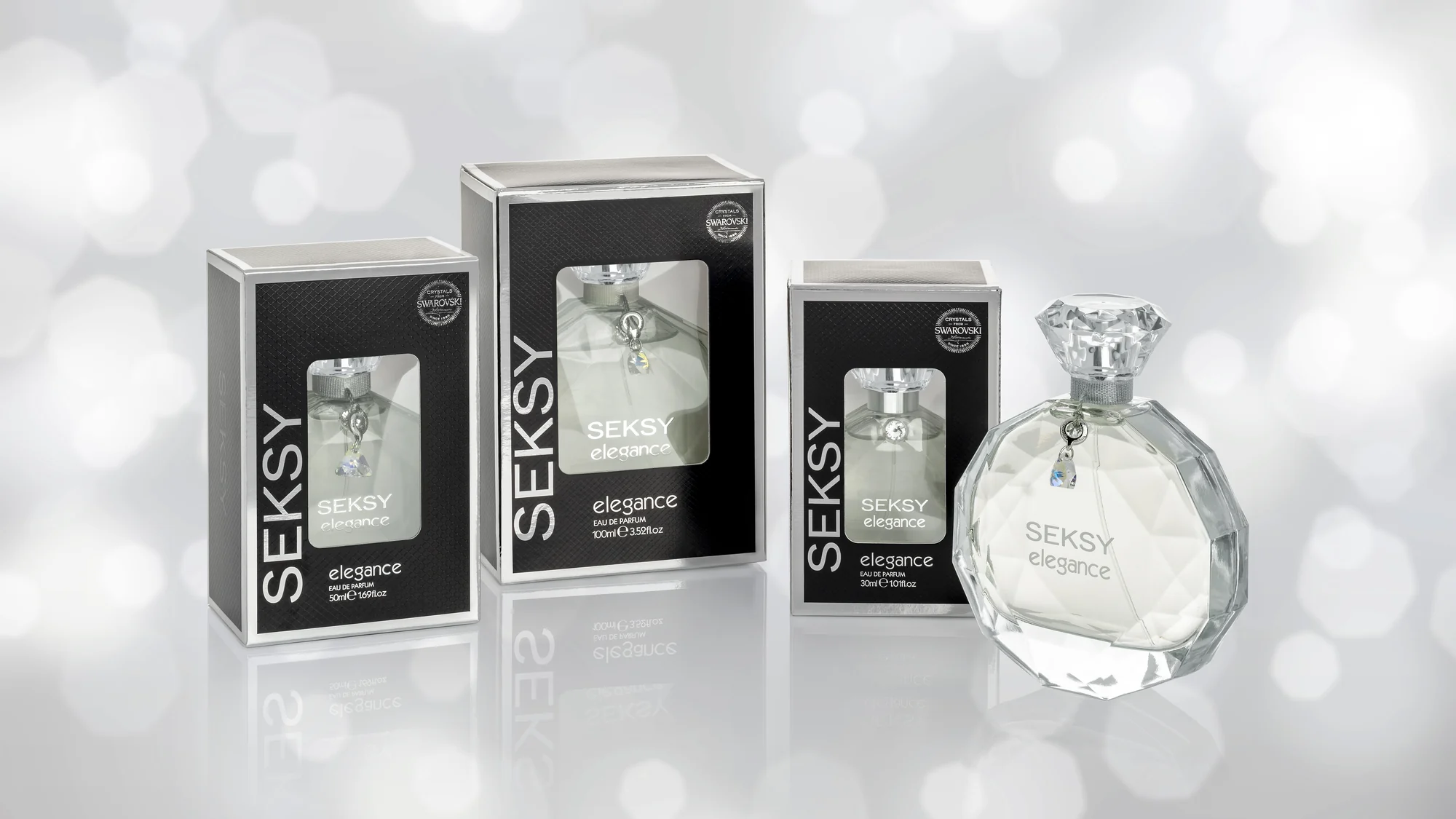 Seksy Elegance eau de parfum with its cartons, photographed against a silver bokeh ground