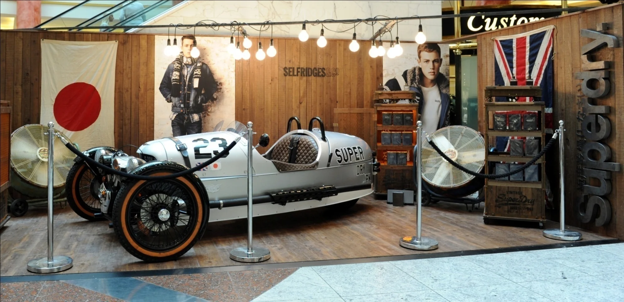 The Superdry fragrance launch installation in Selfridges, built around a vintage three-wheeled racing car
